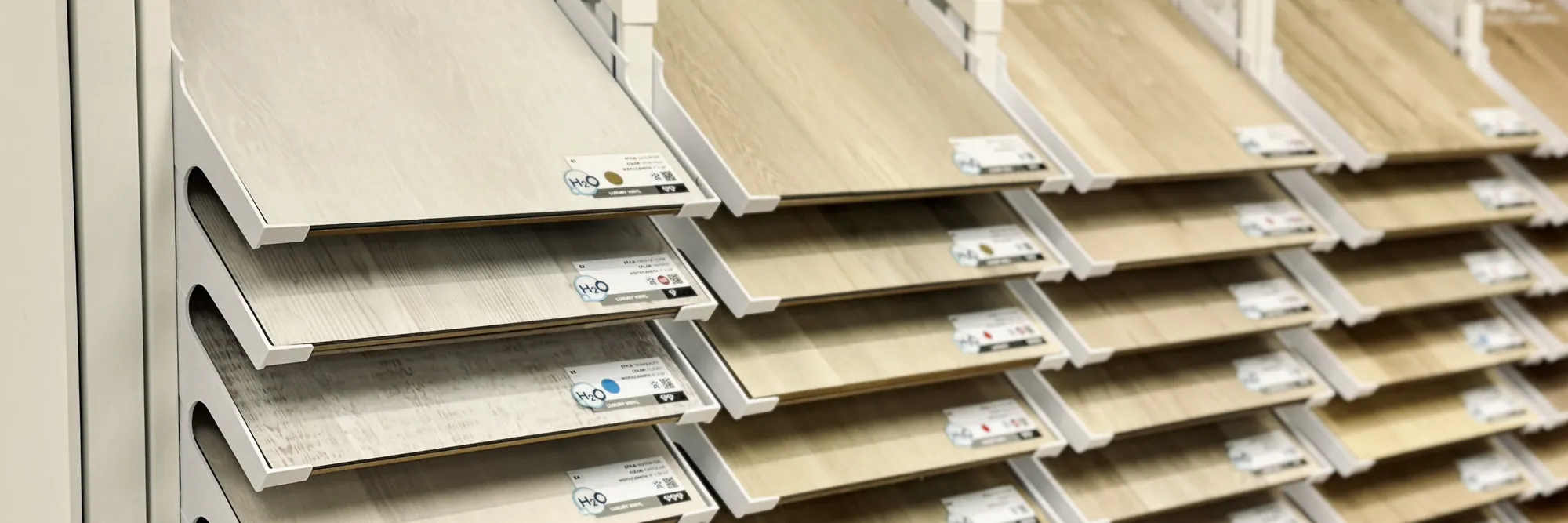 Luxury vinyl plank samples on display racks in Madison’s showroom